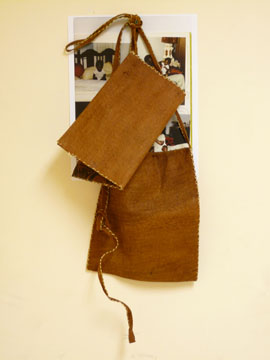 Paul Mpagi Sepuya, "As-yet-untitled work," 2009. Photograph, Ugandan bark-cloth bags, screw. Courtesy the Artist. 