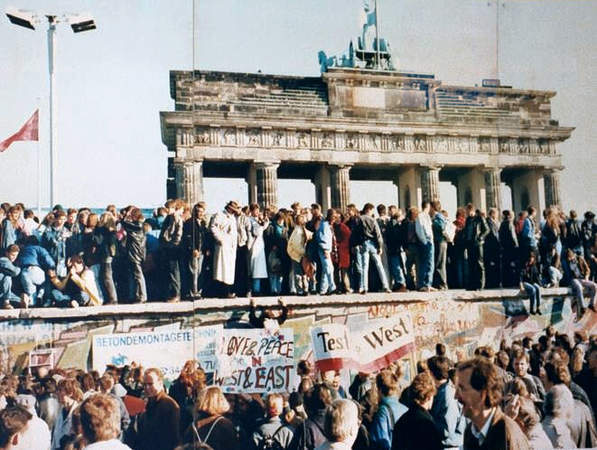 Days before the Berlin Wall is torn down, Germans gather at the wall, 1989. Photographer unknown.