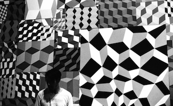 Barry McGee stands in front of one of his geometric creations at Prism Gallery. Courtesy Wallpaper.com.