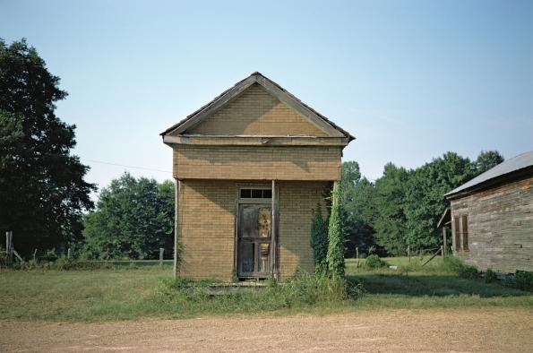 William Christenberry, "Building with False Brick Siding, Warsaw, Alabama (1974)."