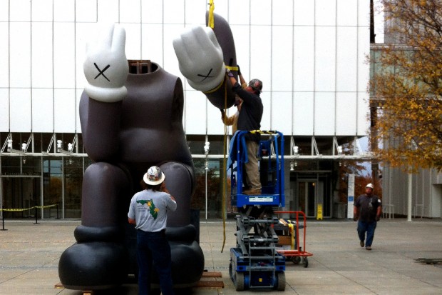 KAWS. Installing Companion Passing Through at the High Museum of Art (2011).