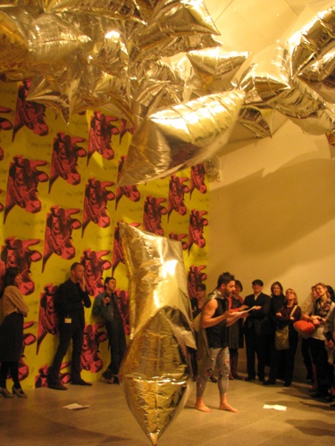 Gutierrez performing "Fuck You, Andy Warhol" as the culmination of his exhibition tour. Warhol's balloons for the dance "Rainforest" by Merce Cunningham circulate throughout the room. Image courtesy The Metropolitan Museum of Art