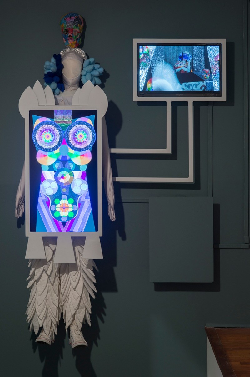 Saya Woolfalk. "ChimaTEK: Hybridization Machine," 2013. Natural and synthetic fabric, foam mannequin, painted steel, converse shoes, plastic skull, glass and plastic beads, 2 television monitors, electronics; 74 wide x 82 high. Courtesy the artist.