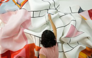 Artist Marela Zacarías works on her large painted sculpture, "Red Meander" (2014), in her Bedford–Stuyvesant studio, Brooklyn, 2014. Production still from the ART21 "New York Close Up" film "Marela Zacarías Goes Big & Goes Home." © ART21, Inc. 2014.