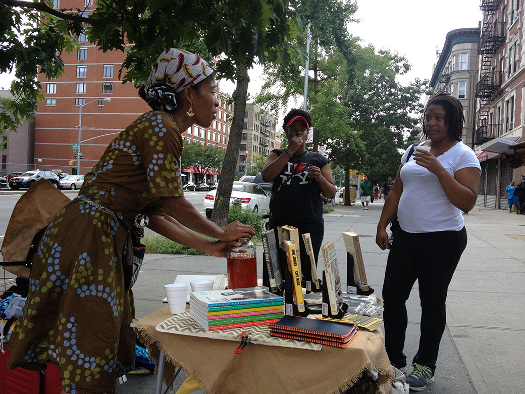 Sharifa Rhodes-Pitts speaks with passersby. Courtesy Sonia Louise Davis.