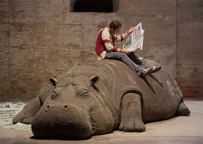Allora & Calzadilla "Hope Hippo," 2005 Mud, whistle, daily newspaper, and live person, approximately 16 x 6 x 5 feet. Installation view: 51st Venice Biennale.  Courtesy the artists.