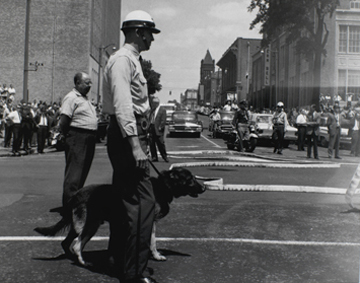 Lonnie J. Wilson, "Birmingham (Policeman with Dog and Fire Hoses)," 1963. Collection of the family of Lonnie J. Wilson. Courtesy High Museum of Art.