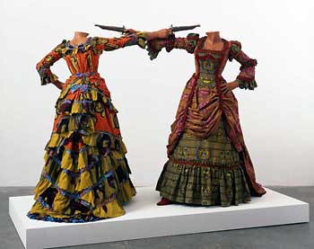 Yinka Shonibare. "How to Blow up Two Heads at Once (Ladies)," 2006. Two-life size mannequins, two guns, Dutch wax printed cotton, shoes, and leather riding boots, Plinth overall 63 x 96 1/2 x 48 inches, each figure 63 x 61 x 48 inches. Collection of Davis Museum and Cultural Center, Wellesley College, Wellesley, MA. Photo by Stephen White, © Yinka Shonibare, MBE, courtesy the artist, James Cohan Gallery, New York and Stephen Friedman Gallery, London.