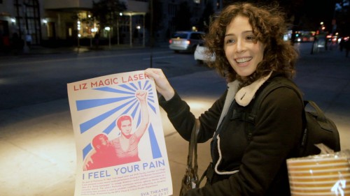 Artist Liz Magic Laser with poster for the Performa-commissioned work "I Feel Your Pain" at the SVA Theater (Chelsea, 11.14.11). Production still from the series 