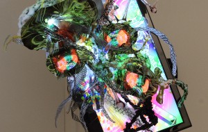 [dNASAb]. “Screenscaping the Pixelsphere,” 2012. (1) 19" LED screen, (3) 4" LCD screens, pigmented plastic prints, clear plastic, wire, glass, crystal, foam, aluminum, resin, mirrors, fiber optics, media player, L.E.D's, 1 of 1 1080p HD video w. audio. Dimensions variable. Photo courtesy of the artist.
