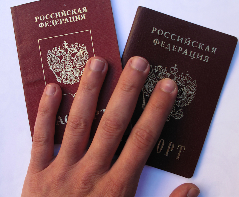 Thomas Strickland, Andrei's Hand on His Passport, 2013; photograph. In conjunction with "Making Neighborhoods." Courtesy the artist.