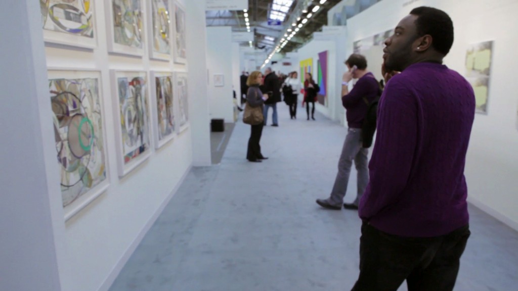 Artist Kalup Linzy tours The Armory Show art fair at Pier 92/94 (Hell’s Kitchen, Manhattan, 03.04.11). Production still from the New York Close Up film Kalup Linzy Makes His Way Through the Art World. © Art21, Inc. 2012. Cinematography by Don Edler.