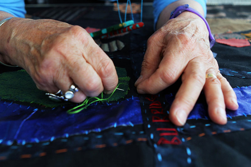 Clara Wainwright works on the Mending Boston Collage Quilt, 2013. Photo: PD Rosso. Courtesy the artist.