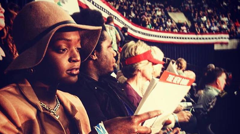 Johari Osayi reading Claudia Rankine’s Citizen at a Trump Rally, November 2015. Photo via Jezebel.