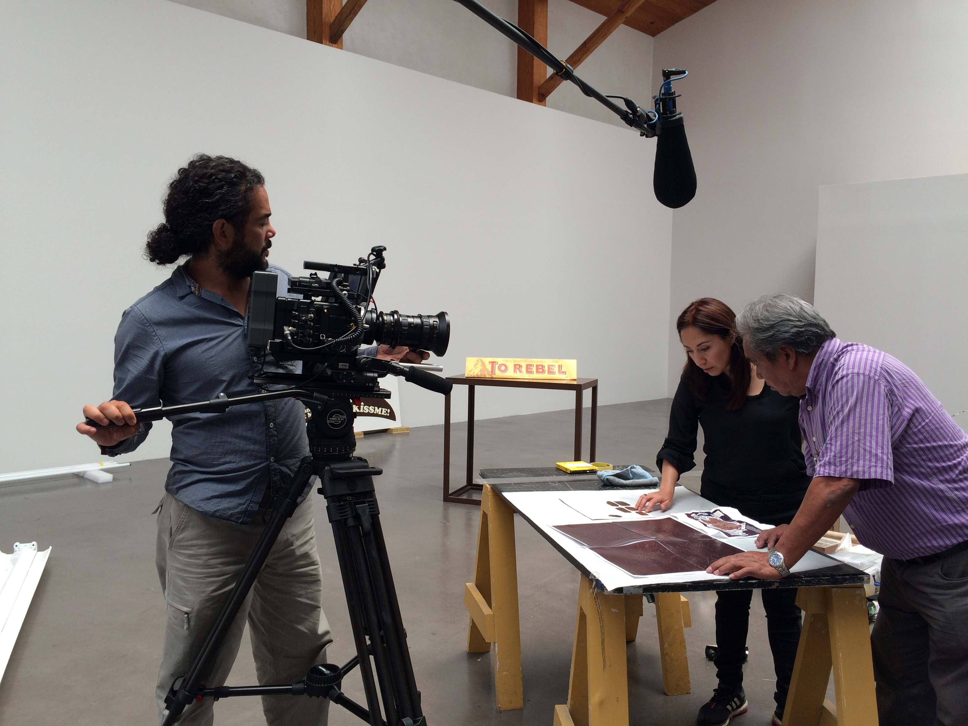ART21 filming Minerva Cuevas installing her work in the exhibition Under the Same Sun: Art from Latin America Today at Museo Jumex in Mexico City. Behind the scenes of ART21’s series Art in the Twenty-First Century, Season 8, 2016. Photo: Ian Forster. © ART21, Inc. 2016.