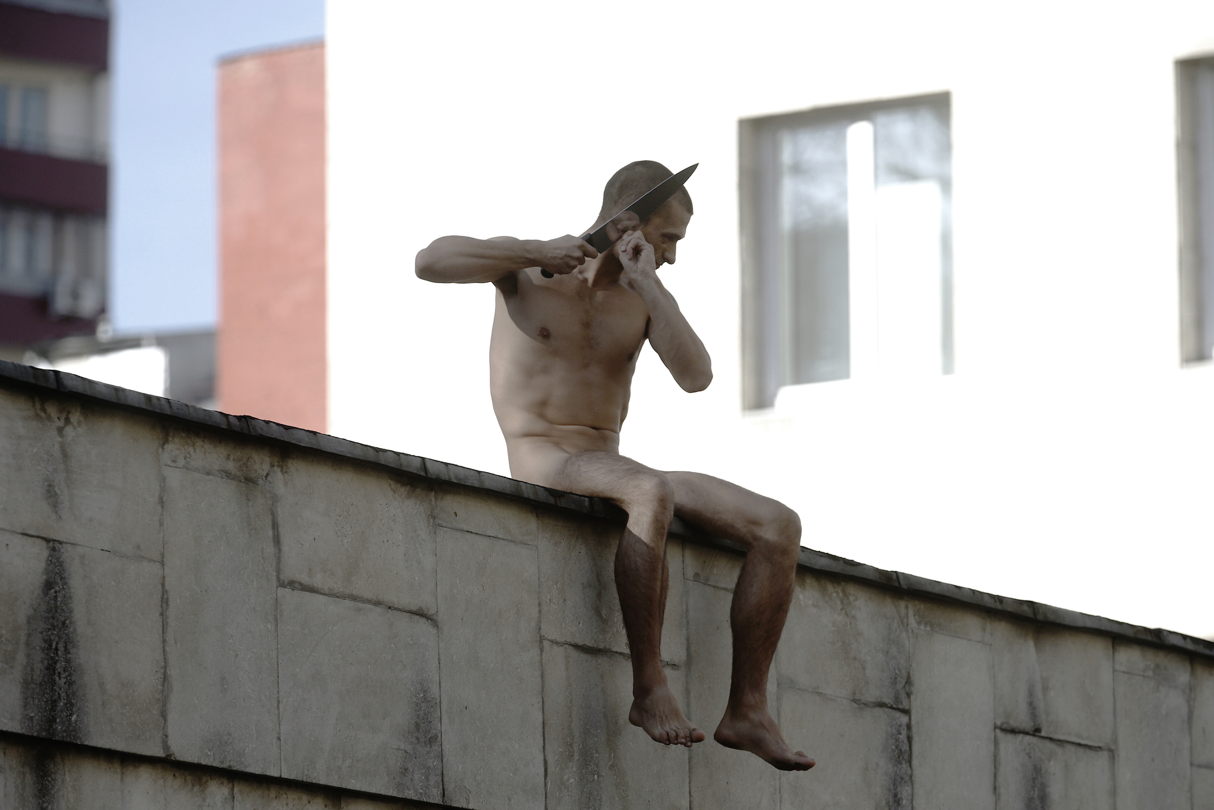 Petr Pavlensky. Segregation, 2015. Performance Still (On the wall to the Serbsky State Scientific Center.) Courtesy of the artist.